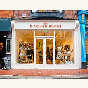 Image of a traditional wooden shop front from the front with the doors closed- The kitchen whisk store in Wicklow Street, Dublin 2